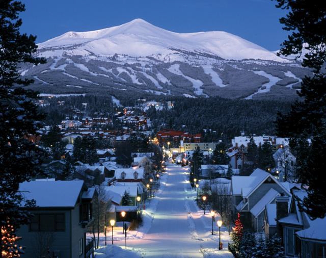 Nighttime image of Breckenridge town with ski slopes in background